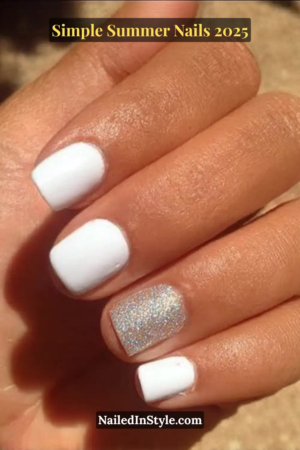 A tanned hand displays short square nails painted in solid white polish, with the ring finger featuring a dazzling silver glitter accent, under direct summer sunlight.