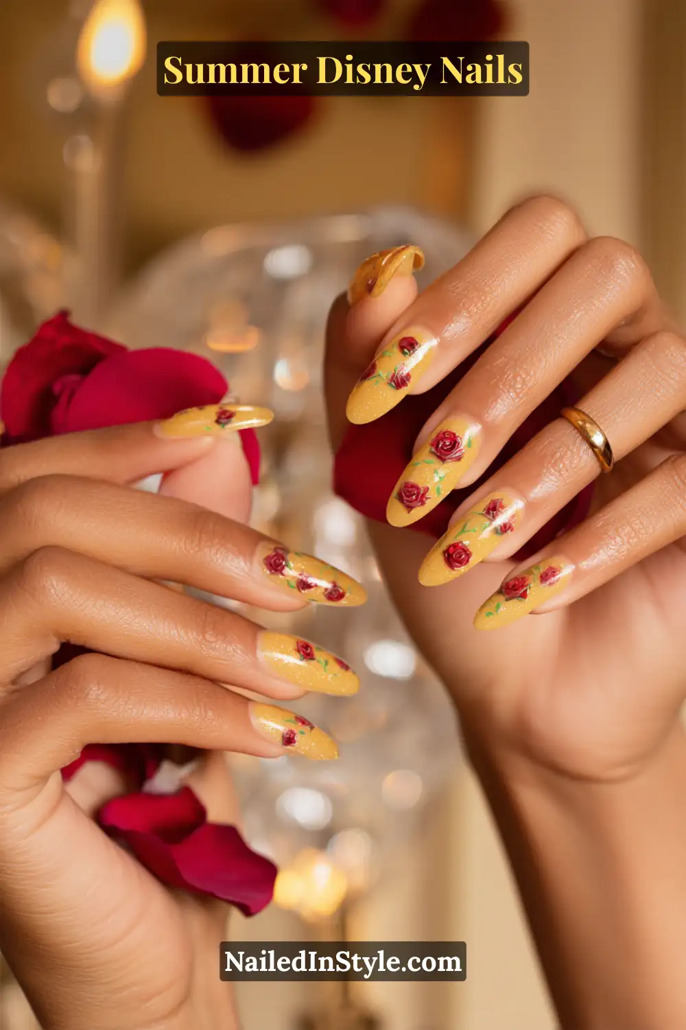 Long almond-shaped nails in Belle’s signature yellow, adorned with tiny hand-painted red roses.