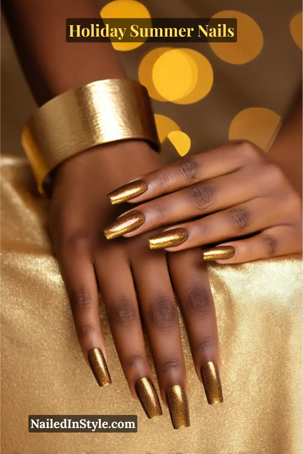 Hands with long square nails painted in shimmering metallic bronze polish, paired with a golden cuff bracelet for a glowing summer holiday vibe.