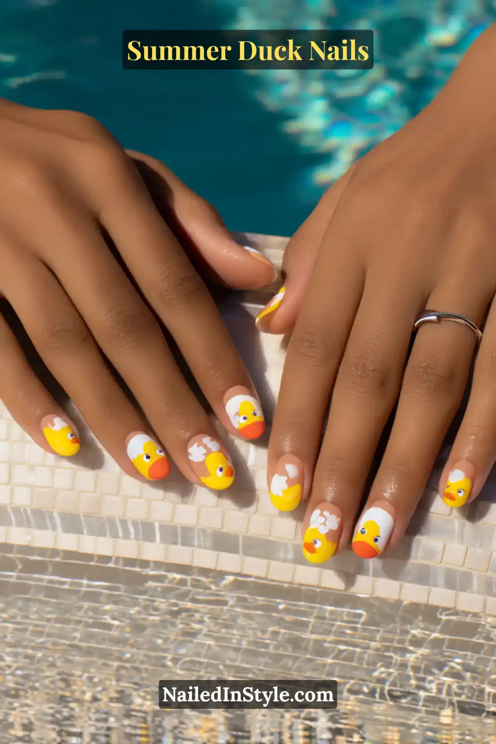 Cute Summer Duck Nails You’ll Want in 2026 4 Bright yellow, orange, and white nails featuring playful rubber duck illustrations with bubbly accents.
