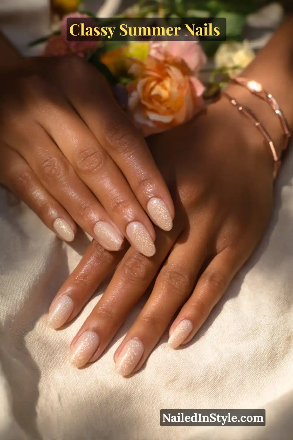 Classy Summer Nails 2026 Trends You’ll Love 14 Almond-shaped nude nails with a champagne base and sparkling gold micro glitter overlay, creating a chic and glamorous summer manicure.