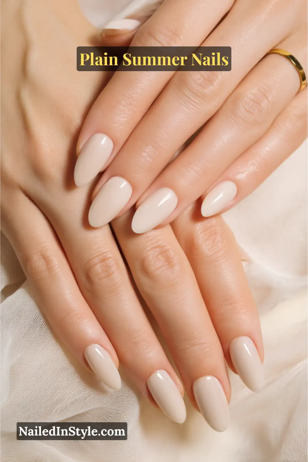 Plain Summer Nails 2025: Simple & Timeless Beauty 2 Close-up of hands with almond-shaped nails painted in glossy beige-nude polish, creating a chic and minimal summer manicure.