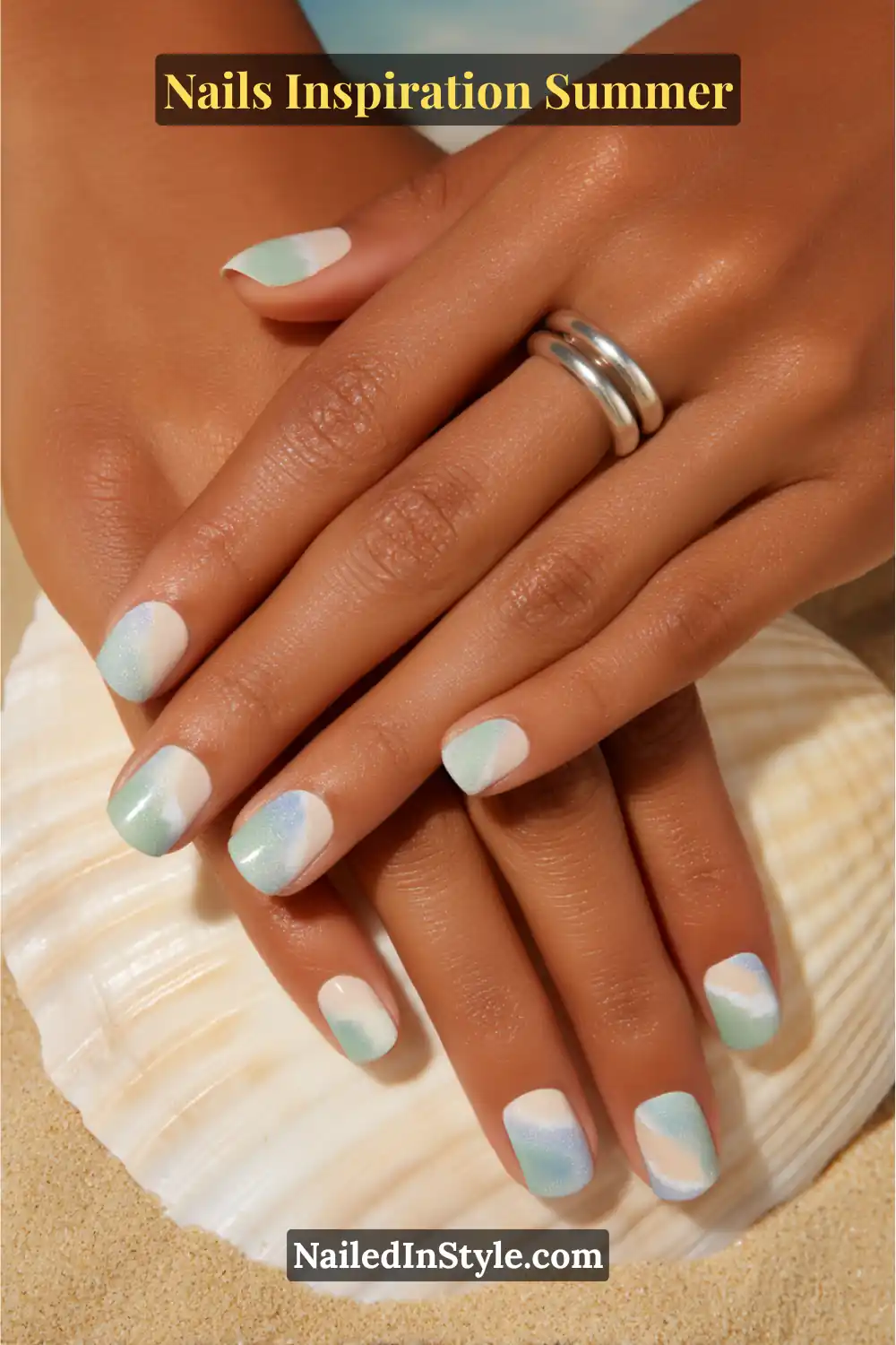 Nails Inspiration Summer 2025: Fresh Trends & Chic Ideas 3 Close-up of coastal-inspired summer nails in sandy beige, seafoam green, and sky blue with an ombré wave design.
