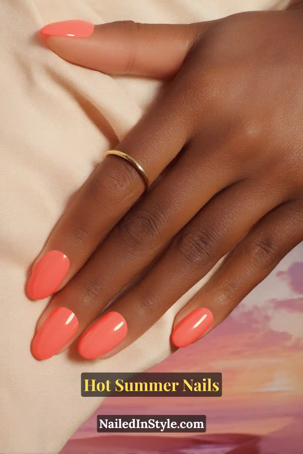 Hot Summer Nails 2025: Bold & Trendy Manicures 20 Close-up of nails painted in a bold solid coral shade, styled with a simple gold ring against a soft pastel background.
