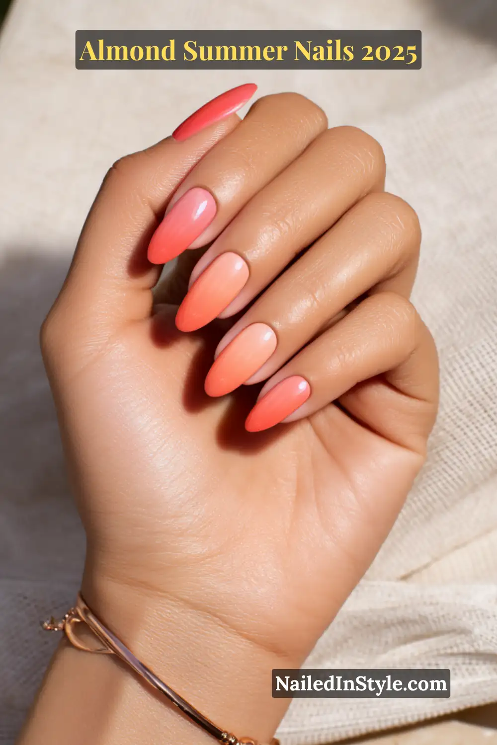 Almond Summer Nails 2025: Sleek, Stylish & Seriously Stunning 12 Hand with almond-shaped nails in a soft coral-to-peach ombré gradient, glossy finish