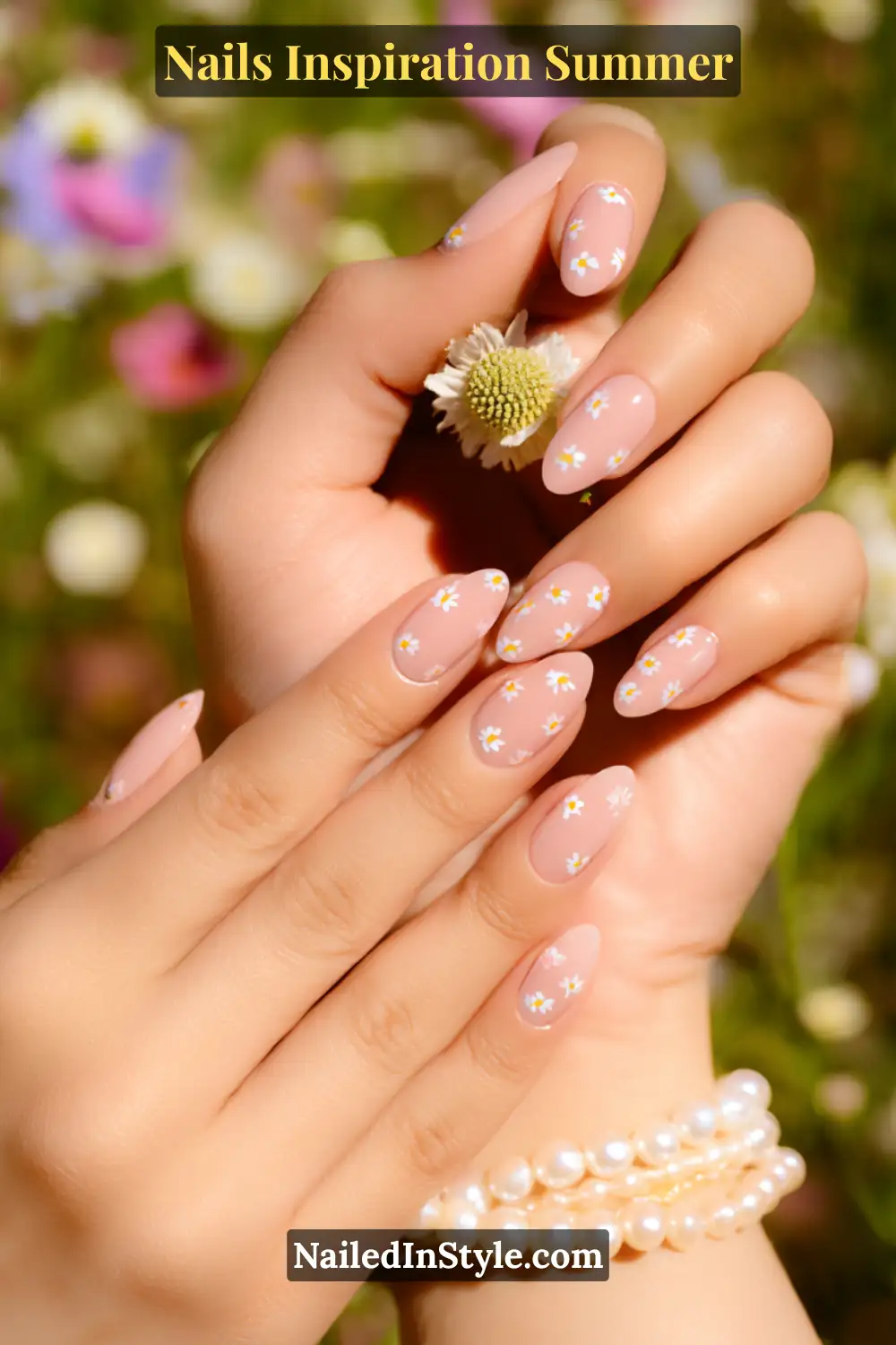 Nails Inspiration Summer 2025: Fresh Trends & Chic Ideas 19 Close-up of almond-shaped nails with a soft nude-pink base, decorated with small white daisy flowers and yellow centers, creating a fresh and feminine summer manicure.