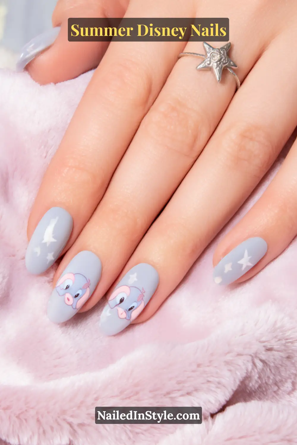 Matte pastel gray nails featuring Dumbo’s sweet pink ears and white star accents for a whimsical Disney-inspired look.