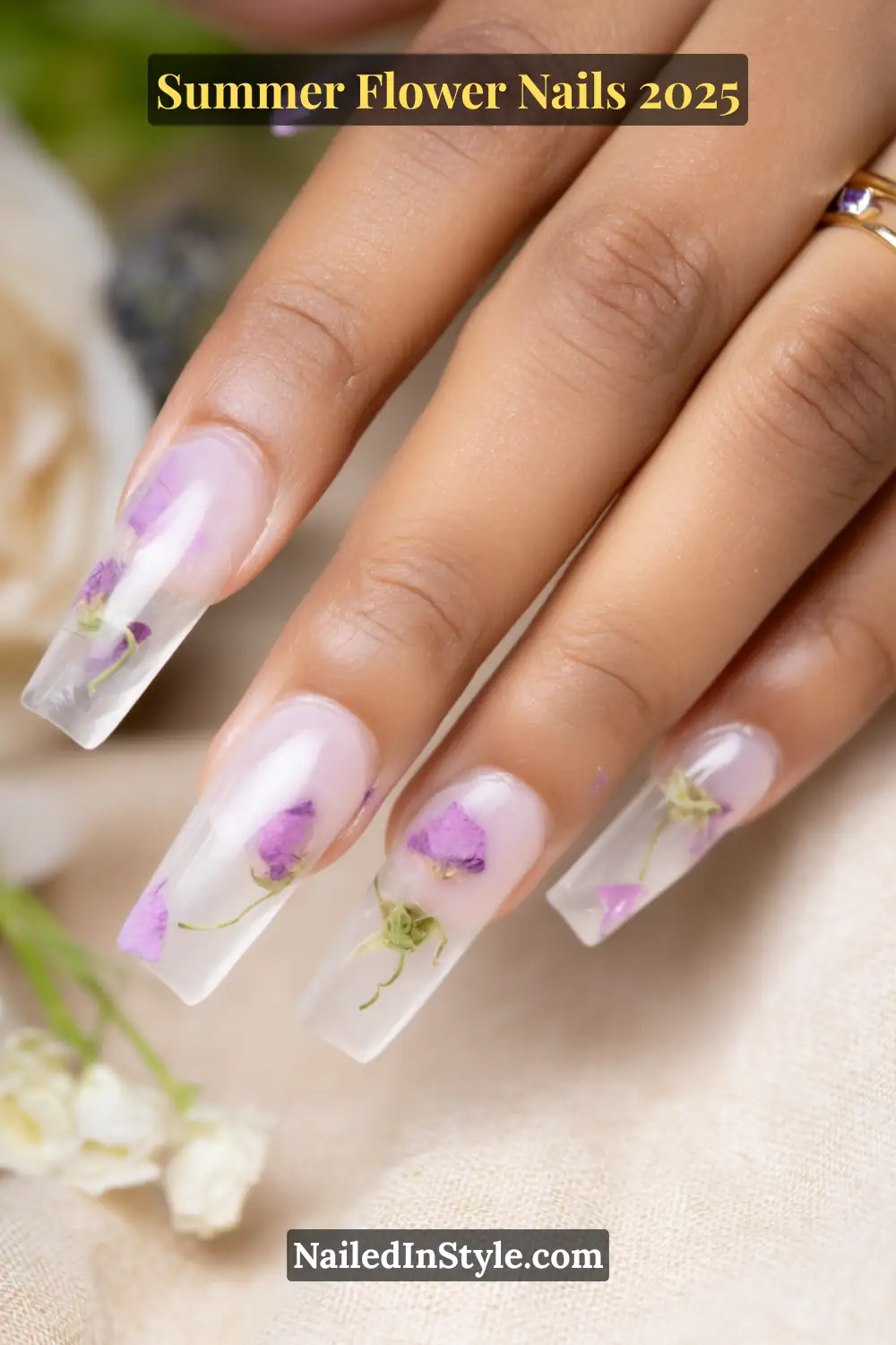 Clear coffin nails with real dried violet petals encapsulated in gel.