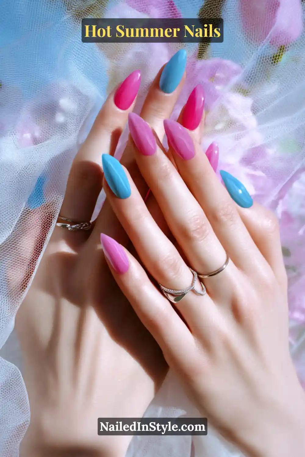 Hot Summer Nails 2025: Bold & Trendy Manicures 7 Close-up of hot pink and icy blue nails on a fair skin tone, designed to brighten and complement lighter complexions.
