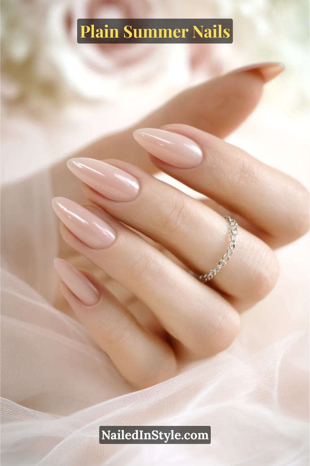 Plain Summer Nails 2025: Simple & Timeless Beauty 7 Close-up of fair hands with almond-shaped nails painted in sheer pink and ivory nude tones, creating a soft and brightening effect.