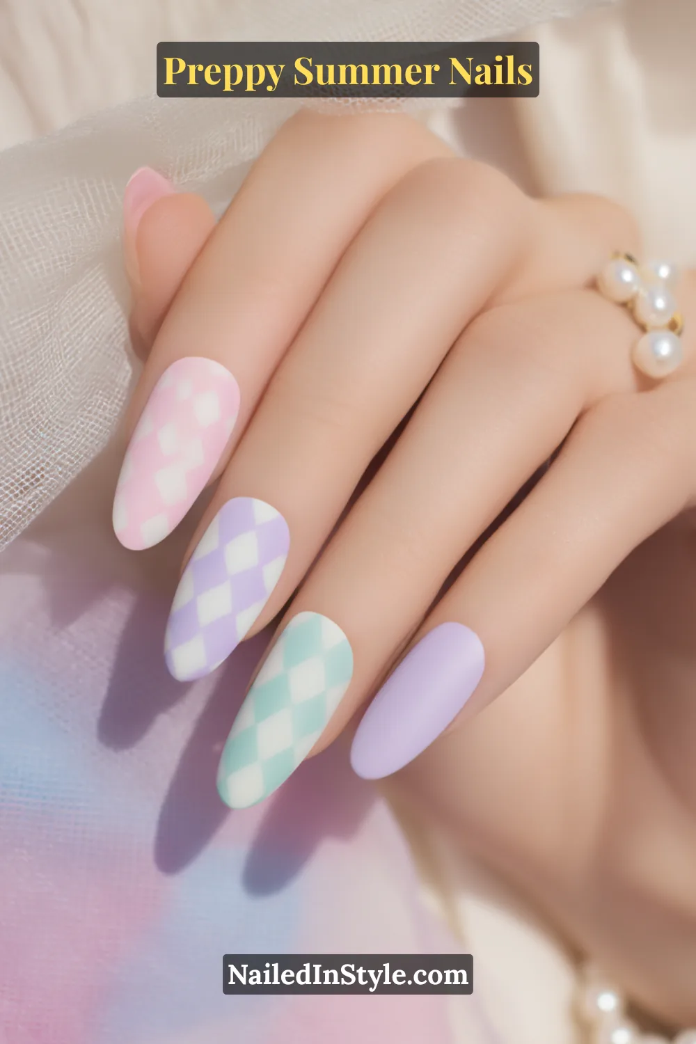 Hand with pastel summer nails in mint, lilac, pink, and white with gingham-style diamond checks.