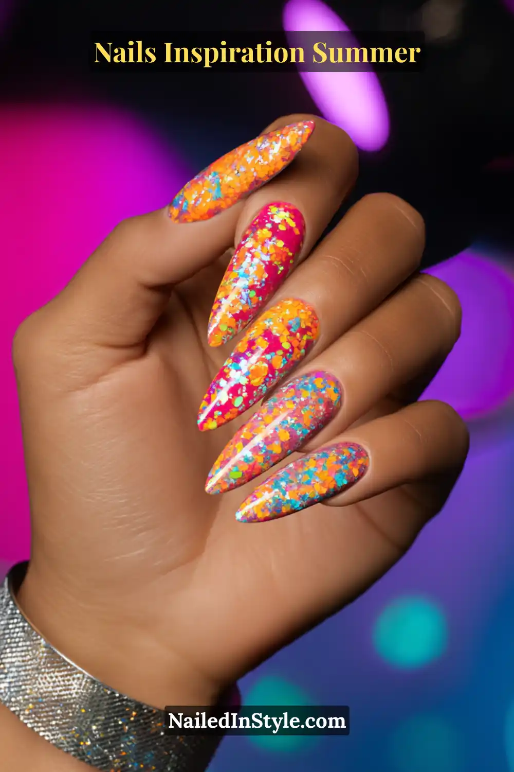 Nails Inspiration Summer 2025: Fresh Trends & Chic Ideas 14 Close-up of long stiletto nails with vibrant pink and orange base, layered with multicolor glitter flakes in turquoise, yellow, and blue, creating a dazzling festival-ready summer manicure.