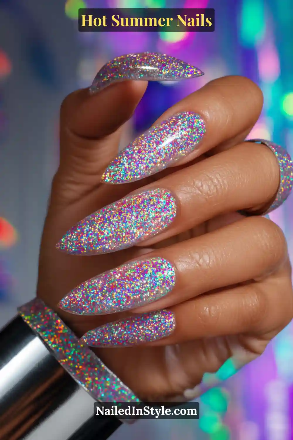 Hot Summer Nails 2025: Bold & Trendy Manicures 5 Close-up of long stiletto nails coated in holographic glitter with multi-dimensional sparkle, creating a dazzling festival-ready manicure.