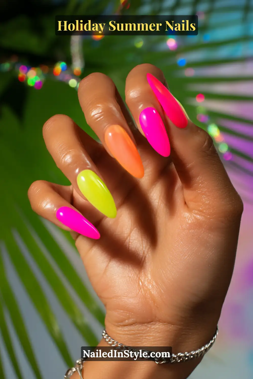 Close-up of vibrant neon holiday nails in hot pink, lime green, and orange, perfect for bold summer vacation vibes.