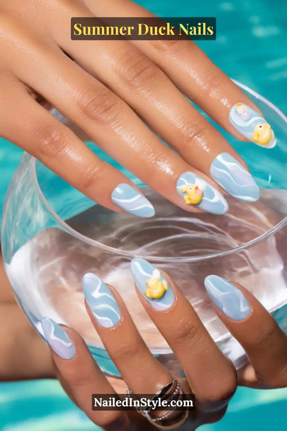Cute Summer Duck Nails You’ll Want in 2026 18 Light blue ripple-patterned nails with 3D yellow duck charms on accent nails.