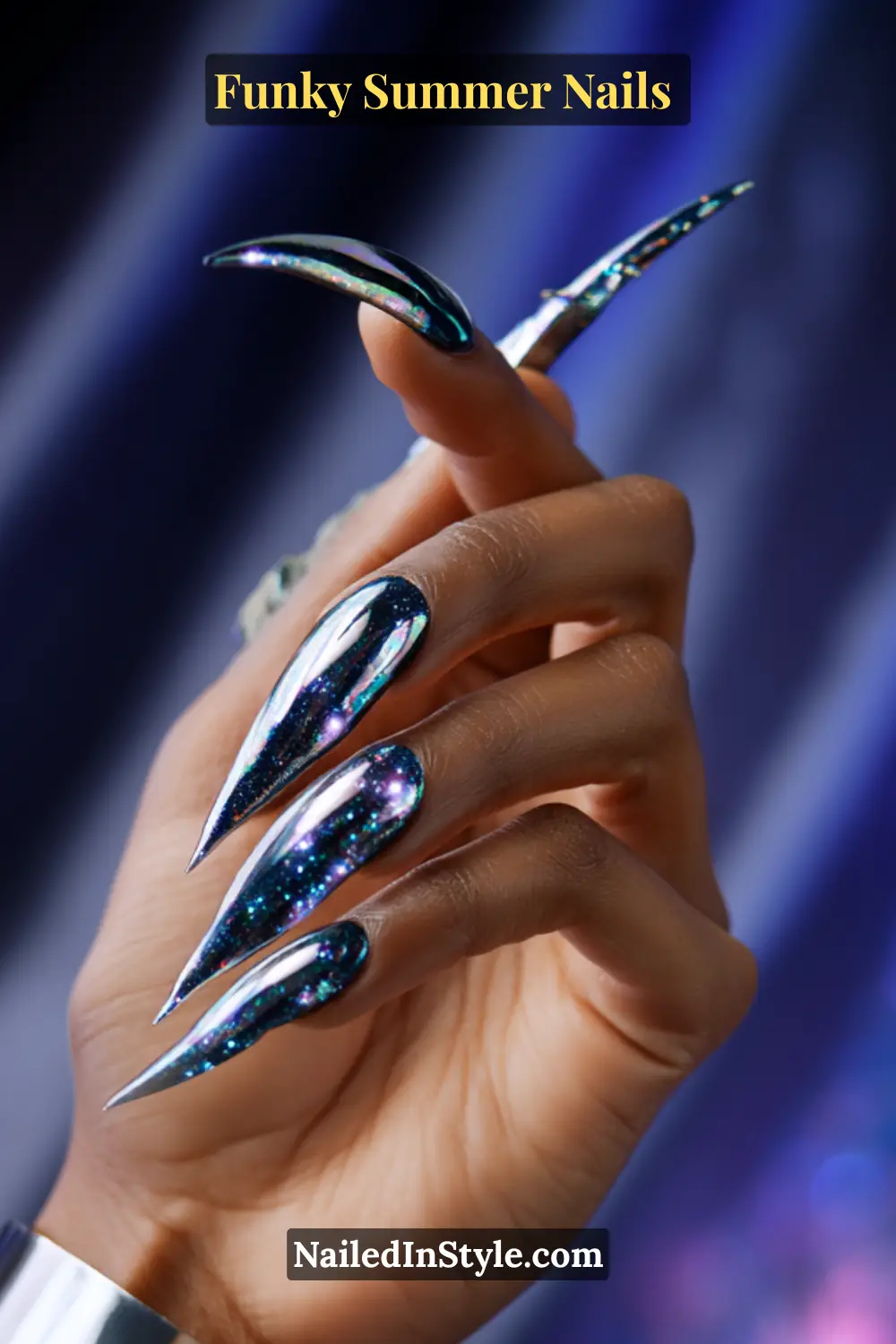 Close-up of extra-long stiletto nails with a galactic chrome effect in deep blue, silver, and holographic purple. The glossy cosmic design features star-like sparkles, creating a futuristic space-inspired look.