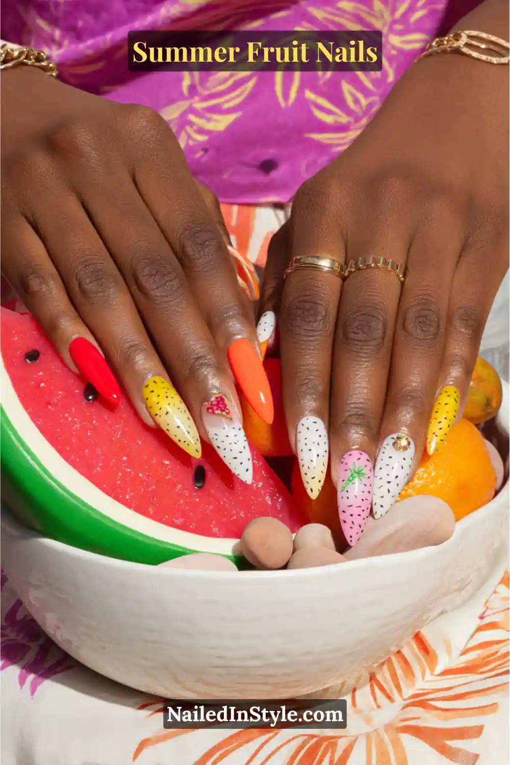 Playful summer nail art inspired by tropical fruits, featuring watermelon red, dragon fruit white with black seeds, pineapple yellow, and pink guava designs.
