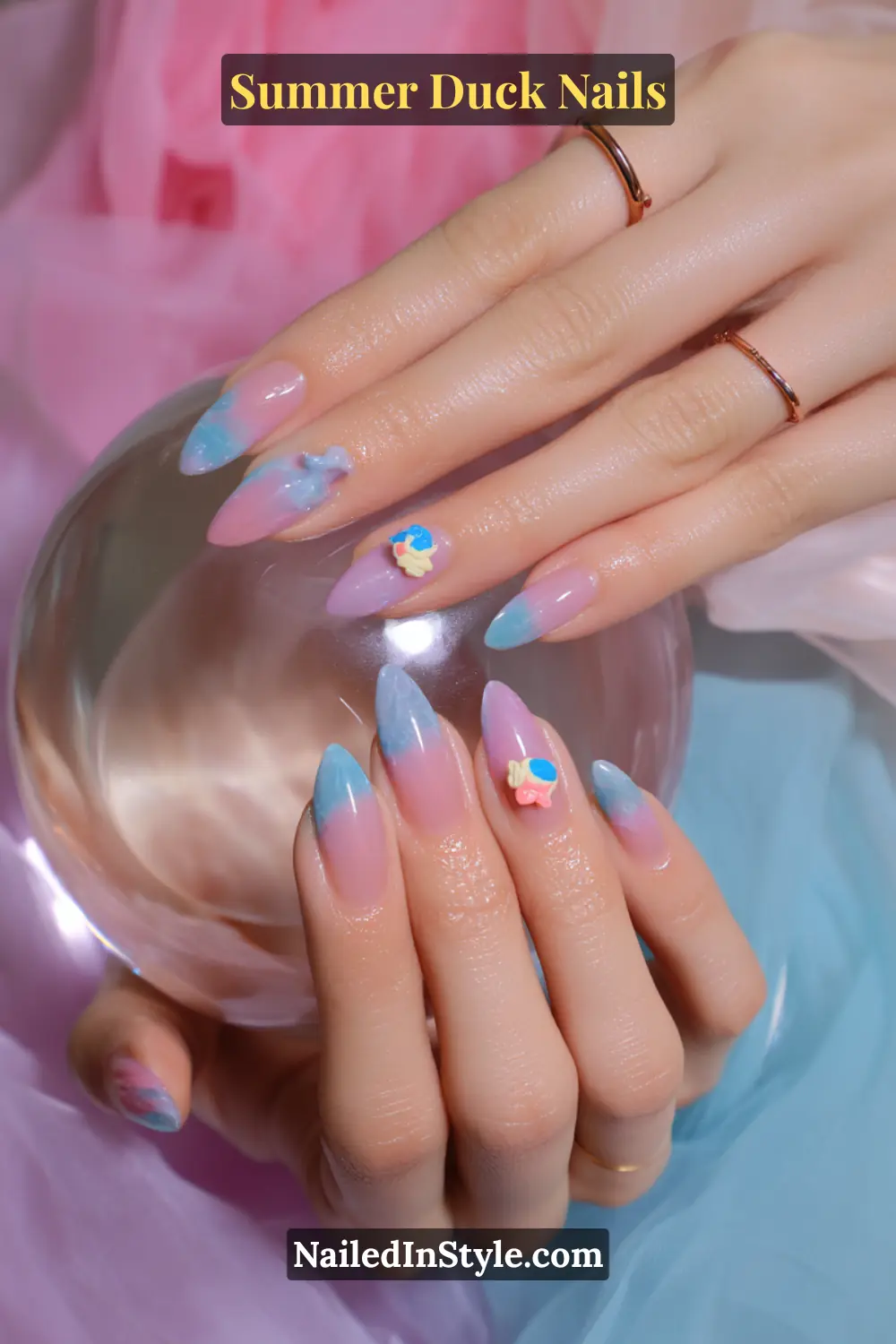 Cute Summer Duck Nails You’ll Want in 2026 16 Long almond nails with a soft pink-to-blue ombre and small 3D duck stickers.