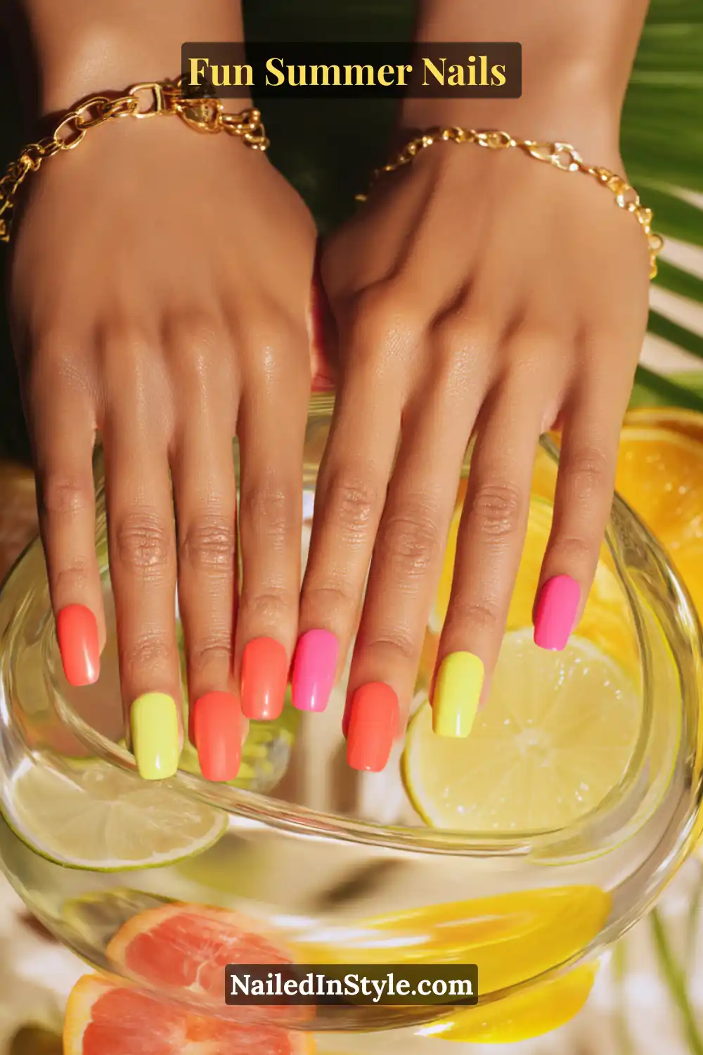 Hands with light skin tone featuring neon yellow, coral, and hot pink nails for a bright and summery pop.