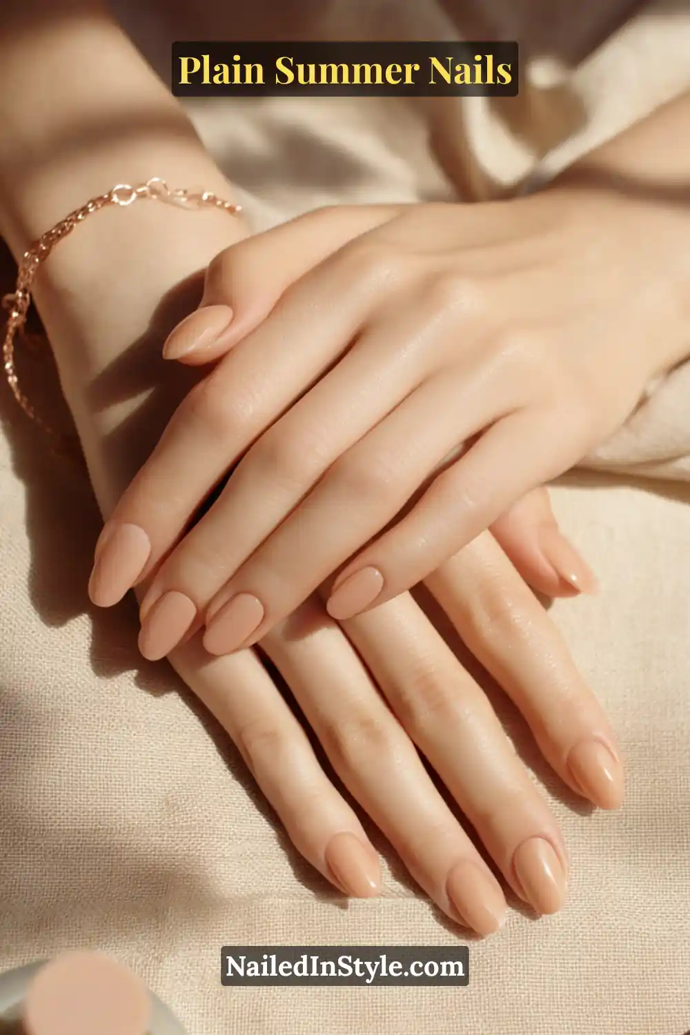 Plain Summer Nails 2025: Simple & Timeless Beauty 8 Close-up of light-toned hands with almond-shaped nails painted in peach beige and sandy nude shades, adding a subtle warmth without overpowering.