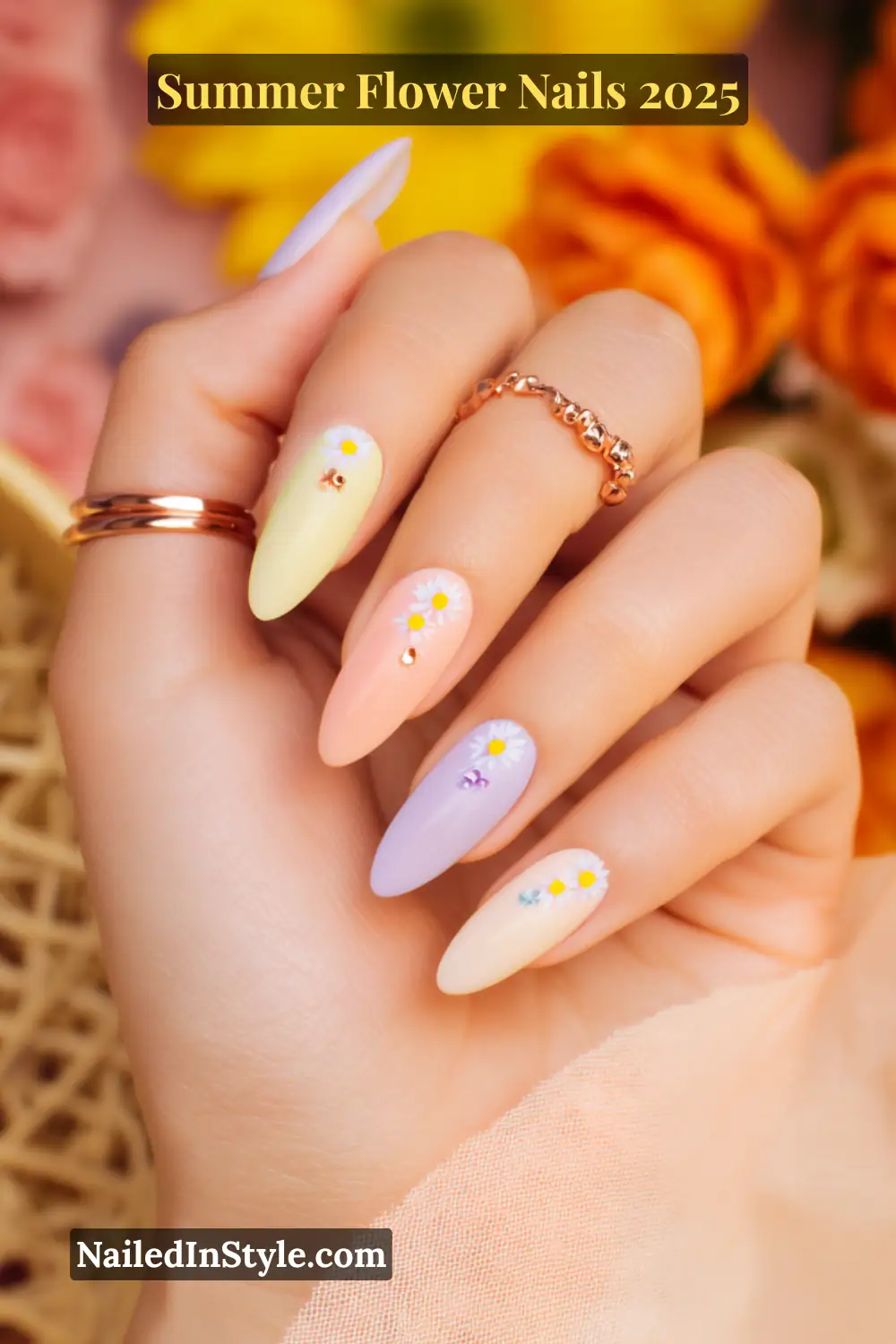Almond-shaped nails in pastel yellow, coral, lavender, and nude on light skin, with daisy decals and rhinestones.