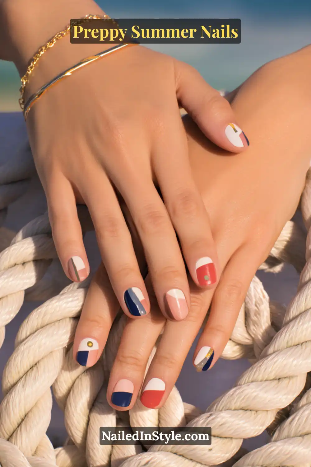 Preppy Summer Nails Hands with nautical summer nails in navy, red, white, and nude with striped and color-block accents.