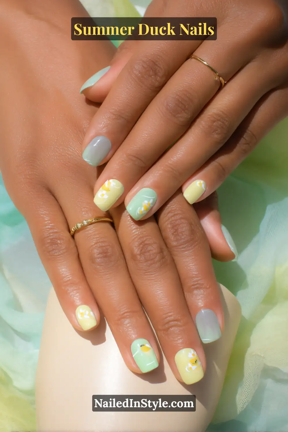 Cute Summer Duck Nails You’ll Want in 2026 8 Mint green and soft yellow nails with delicate duck and floral designs, perfect for light skin tones.