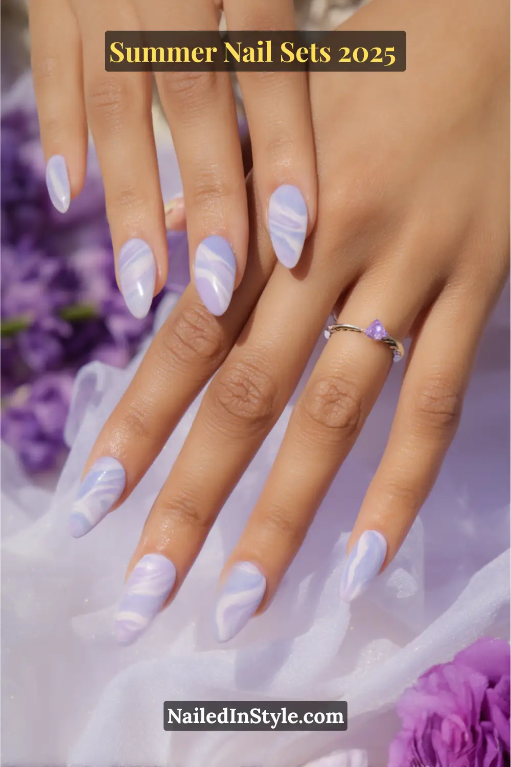 Stunning Summer Nail Sets You’ll Want This Season 18 Elegant summer nails with soft lilac and white watercolor swirl design on almond-shaped tips.