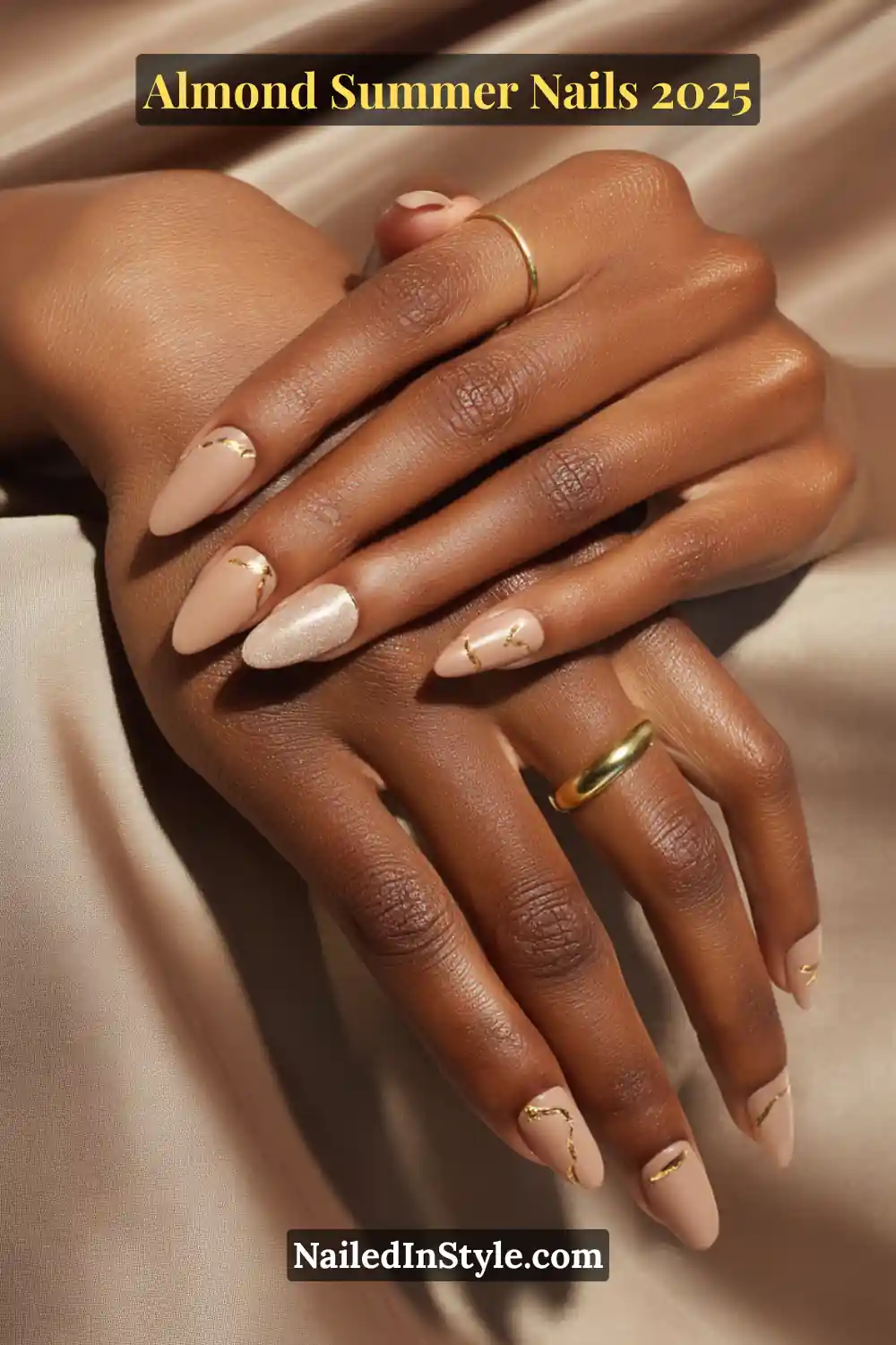 Almond Summer Nails 2025: Sleek, Stylish & Seriously Stunning 4 Almond-shaped nude nails with elegant gold line accents on dark skin, styled with gold rings