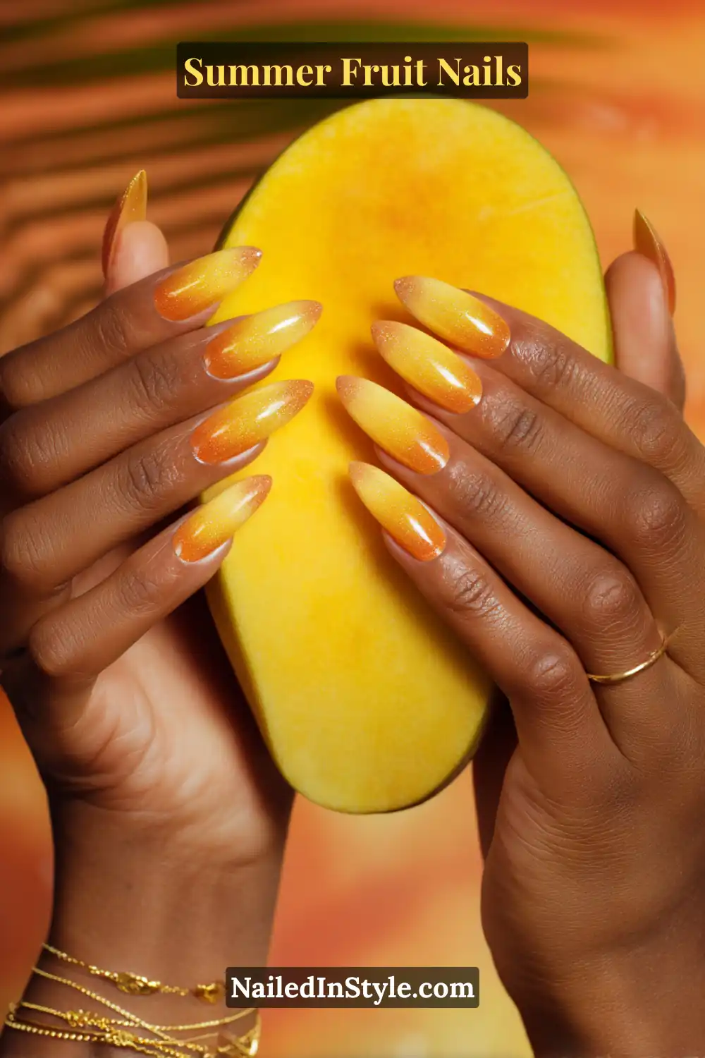 ong almond-shaped nails with a vibrant yellow-to-orange gradient, creating a juicy mango-inspired effect.