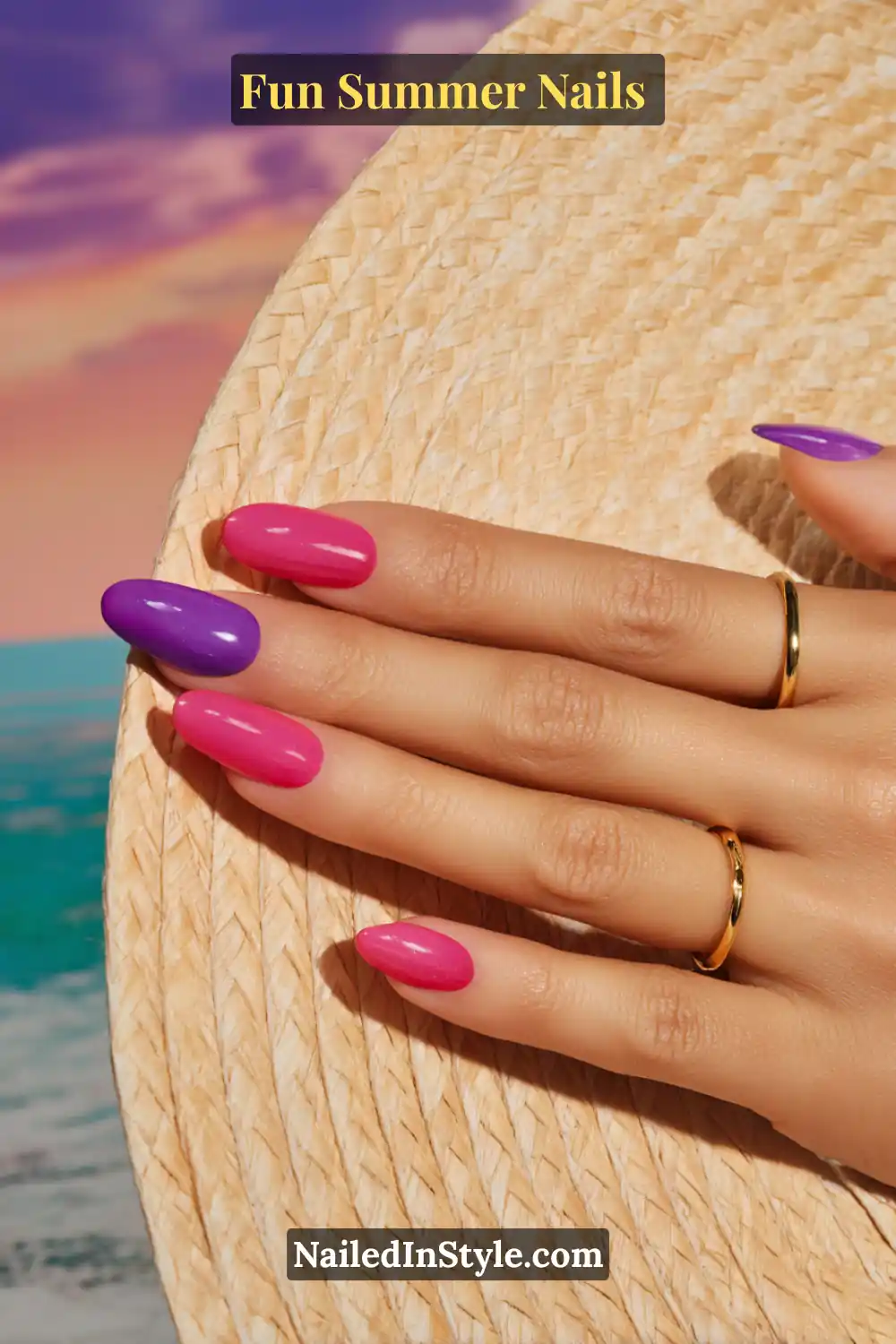 Hand with medium skin tone featuring purple and hot pink nails, styled against a beachy sunset backdrop with a straw hat.