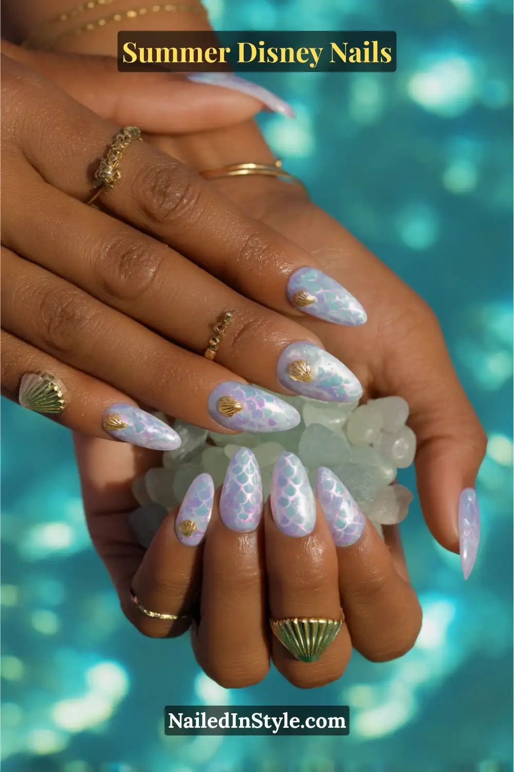 Shimmery aqua and purple mermaid-scale nails with golden seashell charms.