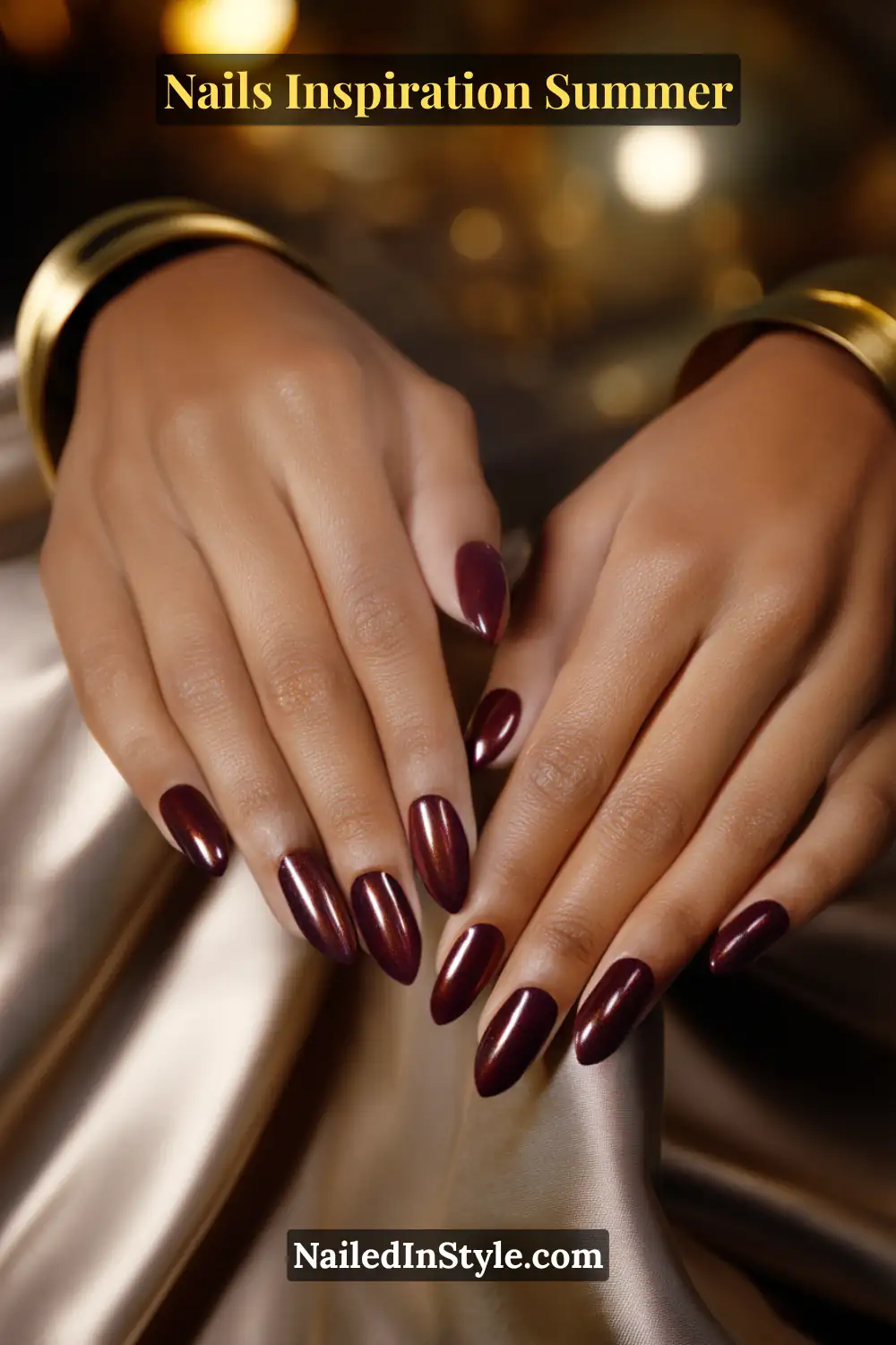 Nails Inspiration Summer 2025: Fresh Trends & Chic Ideas 11 Close-up of long almond-shaped nails in deep burgundy with a subtle bronze shimmer finish, enhancing richness and depth against deep skin tones.