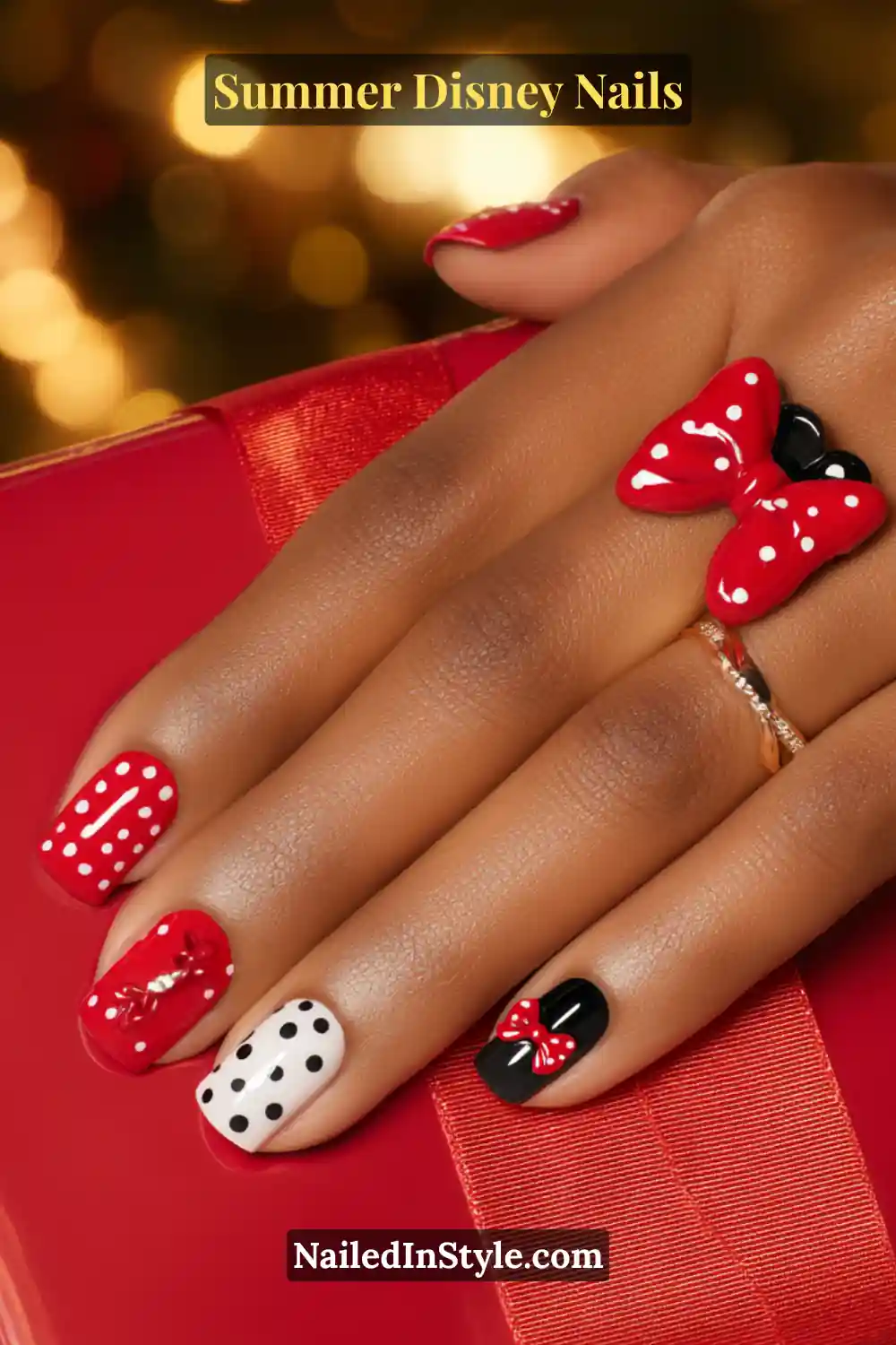 Summer Disney Nails Bold red, black, and white nails with polka dots and red bow designs inspired by Minnie Mouse.