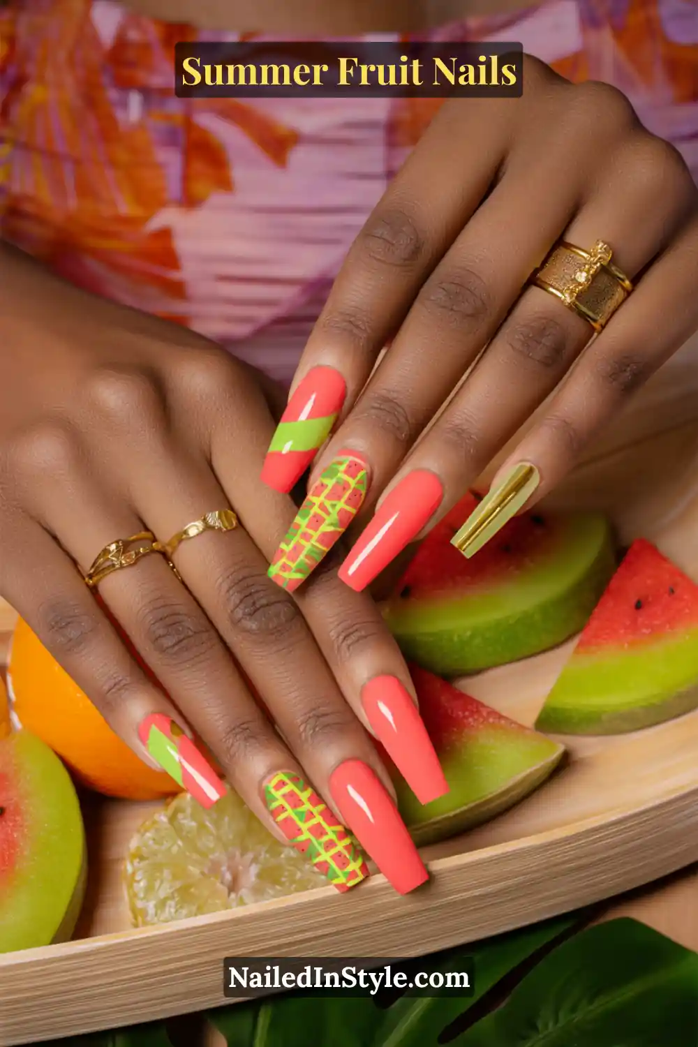 Long square nails in coral and lime, with a mix of solid colors, diagonal stripes, and pineapple-inspired grid designs.