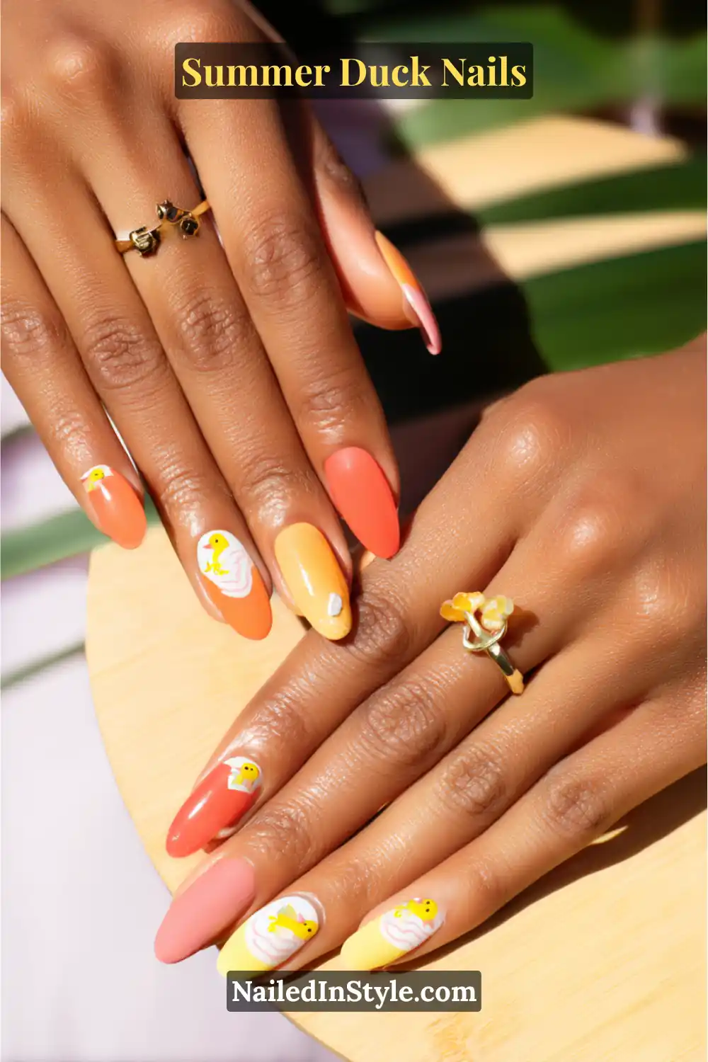 Cute Summer Duck Nails You’ll Want in 2026 9 Coral and yellow nails with playful duck illustrations, designed to pop against golden olive skin tones.