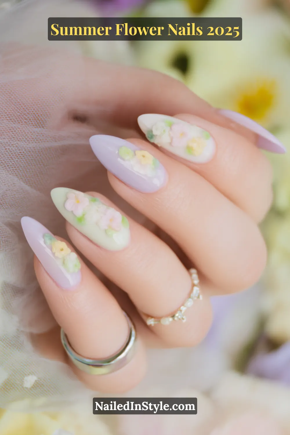 Soft mint and lilac almond nails with detailed 3D floral clusters.