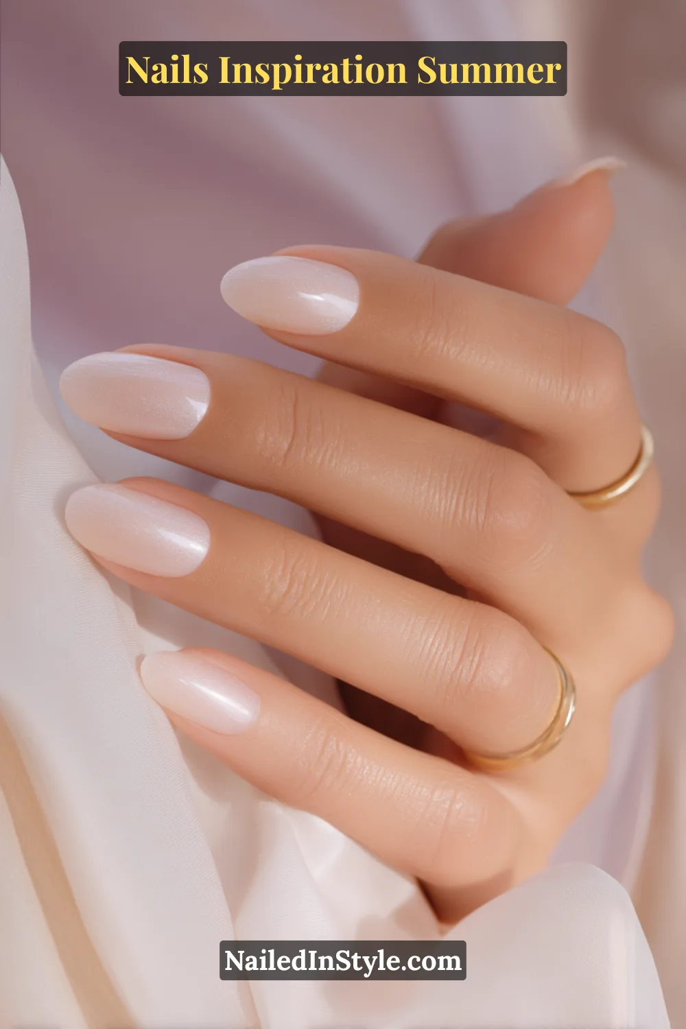 Nails Inspiration Summer 2025: Fresh Trends & Chic Ideas 8 Close-up of short almond-shaped nails painted in a sheer pearly nude shade with a glossy finish, creating a soft and elegant summer manicure.