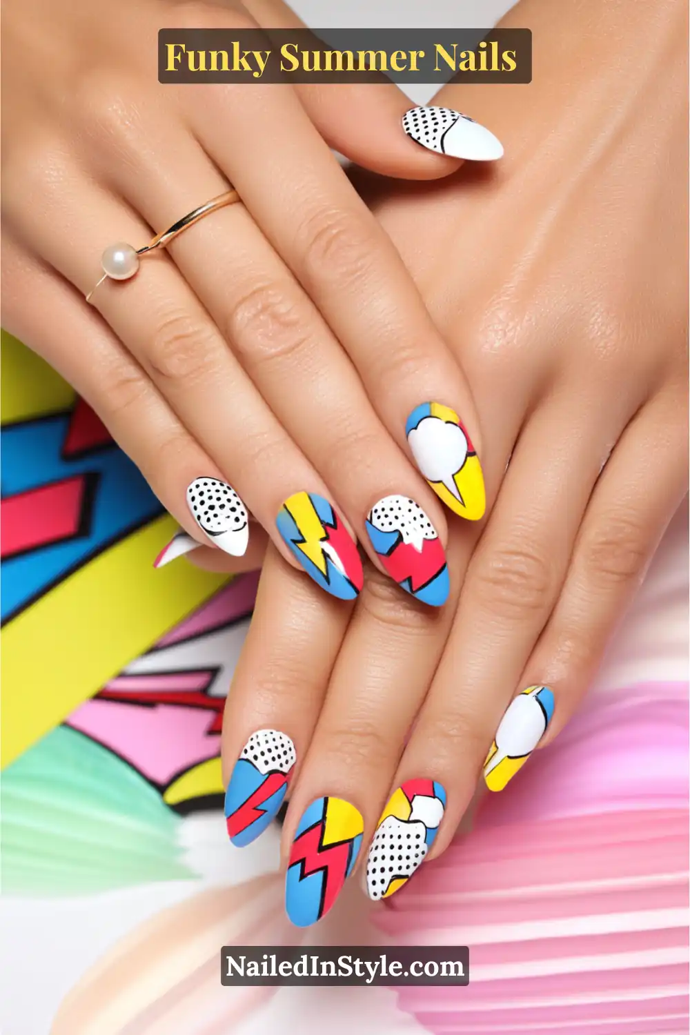 Hands with funky pop art nails featuring comic-style accents, lightning bolts, polka dots, and bright color blocks in red, blue, yellow, and white.