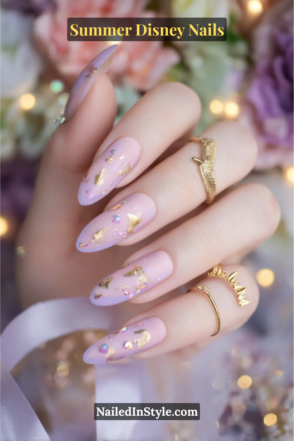 Baby pink and lavender nails with gold foil, rhinestone sparkle accents, and a regal tiara charm.