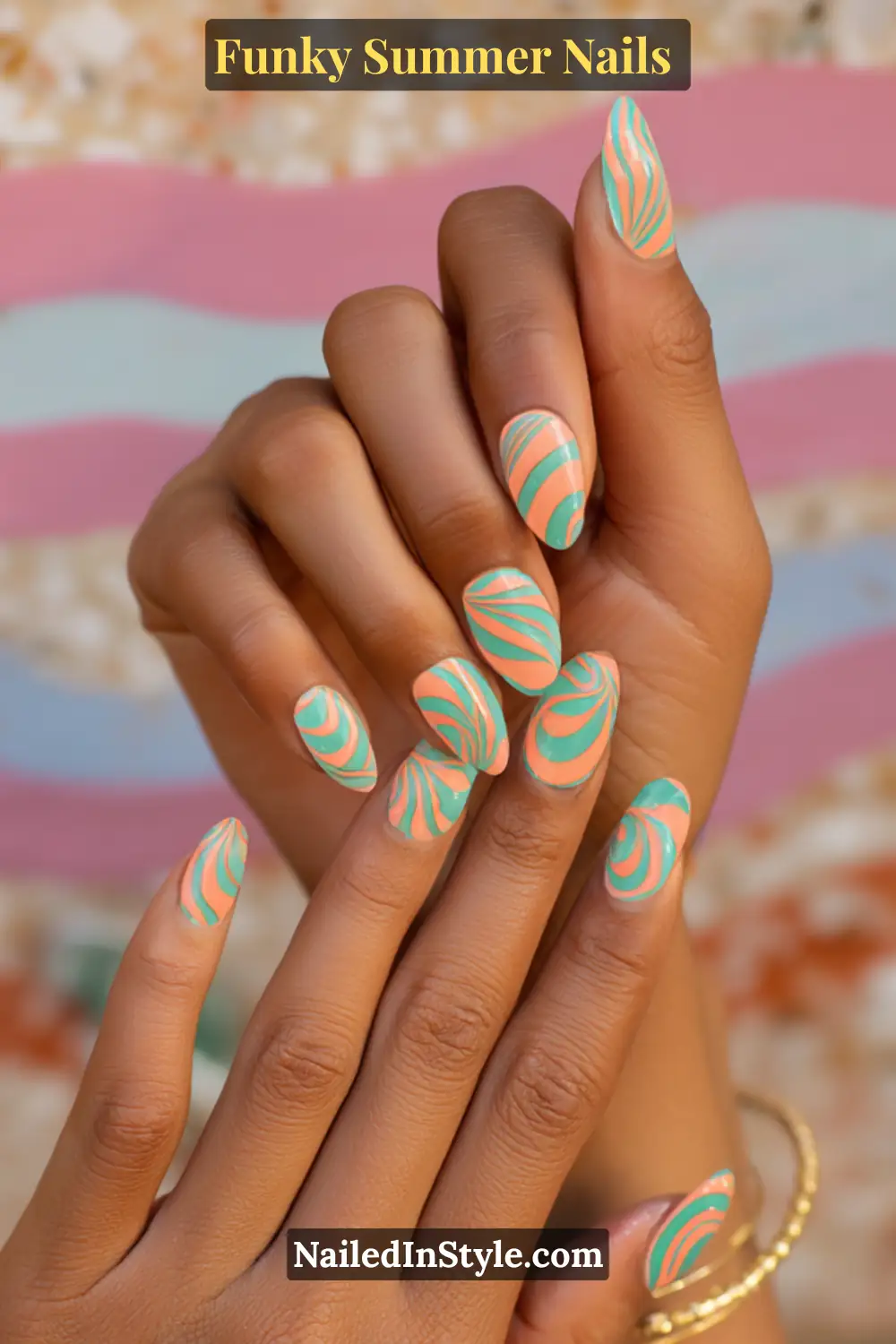 Close-up of almond-shaped nails painted with bold orange and teal swirl patterns. The glossy retro design channels a funky 70s aesthetic with playful curves and vibrant contrast.