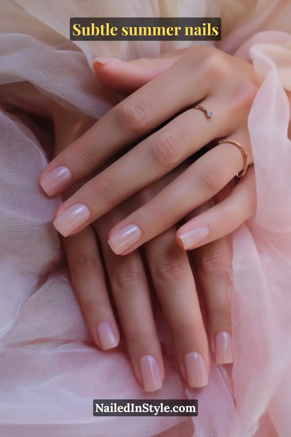 Short square nails painted with a sheer rosy nude polish, creating a natural and glossy finish.