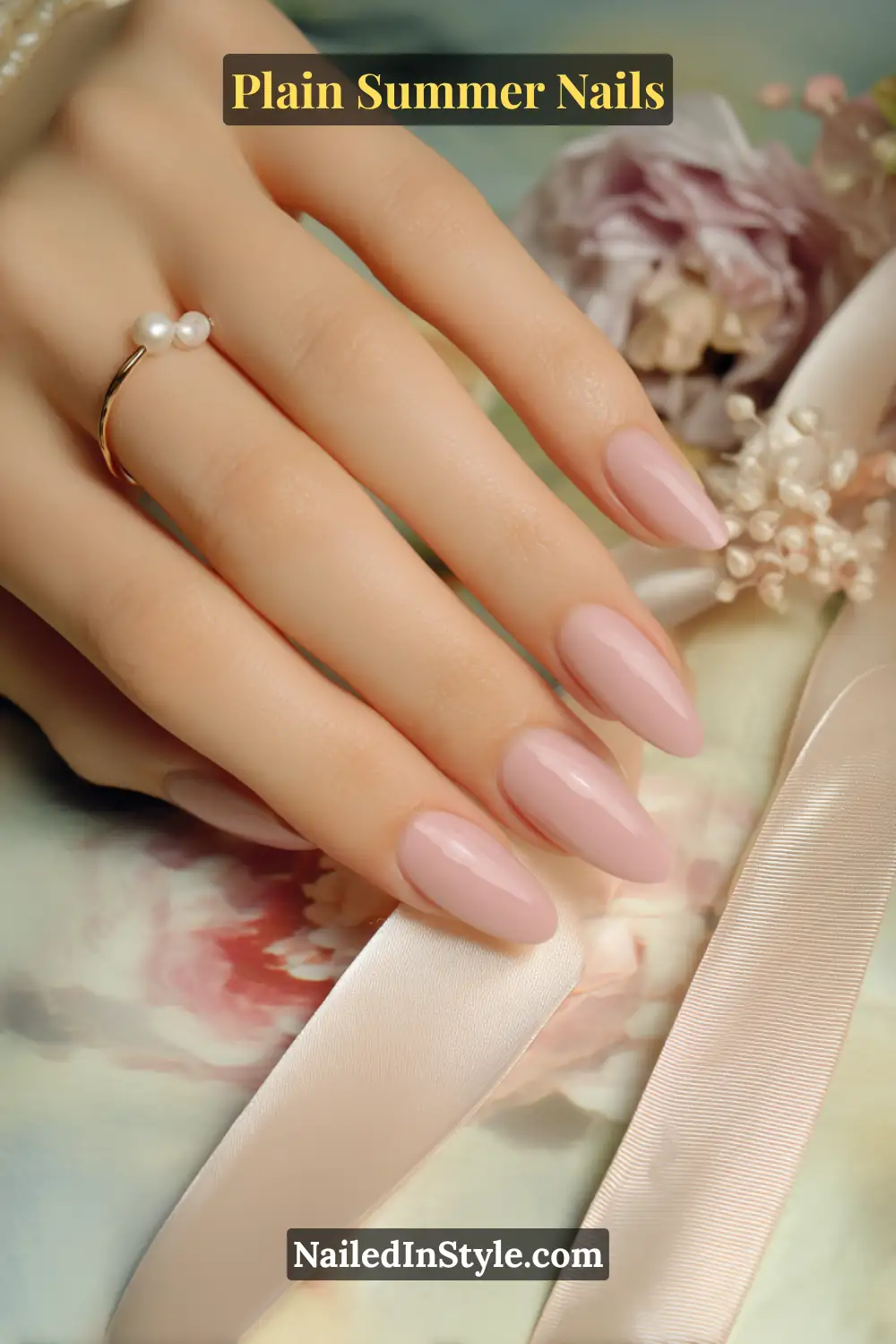 Plain Summer Nails 2025: Simple & Timeless Beauty 3 Close-up of elegant hands with almond-shaped nails painted in sheer blush pink polish, styled with a pearl ring for a delicate summer look.