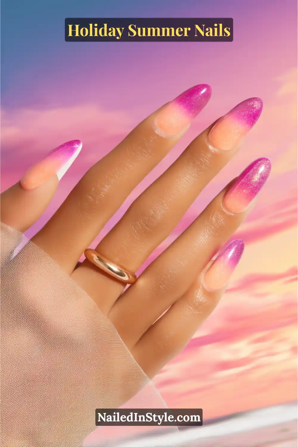 Hand with sunset-inspired ombré manicure featuring a gradient from peach to magenta with gold shimmer, set against a dreamy beach sunset background.