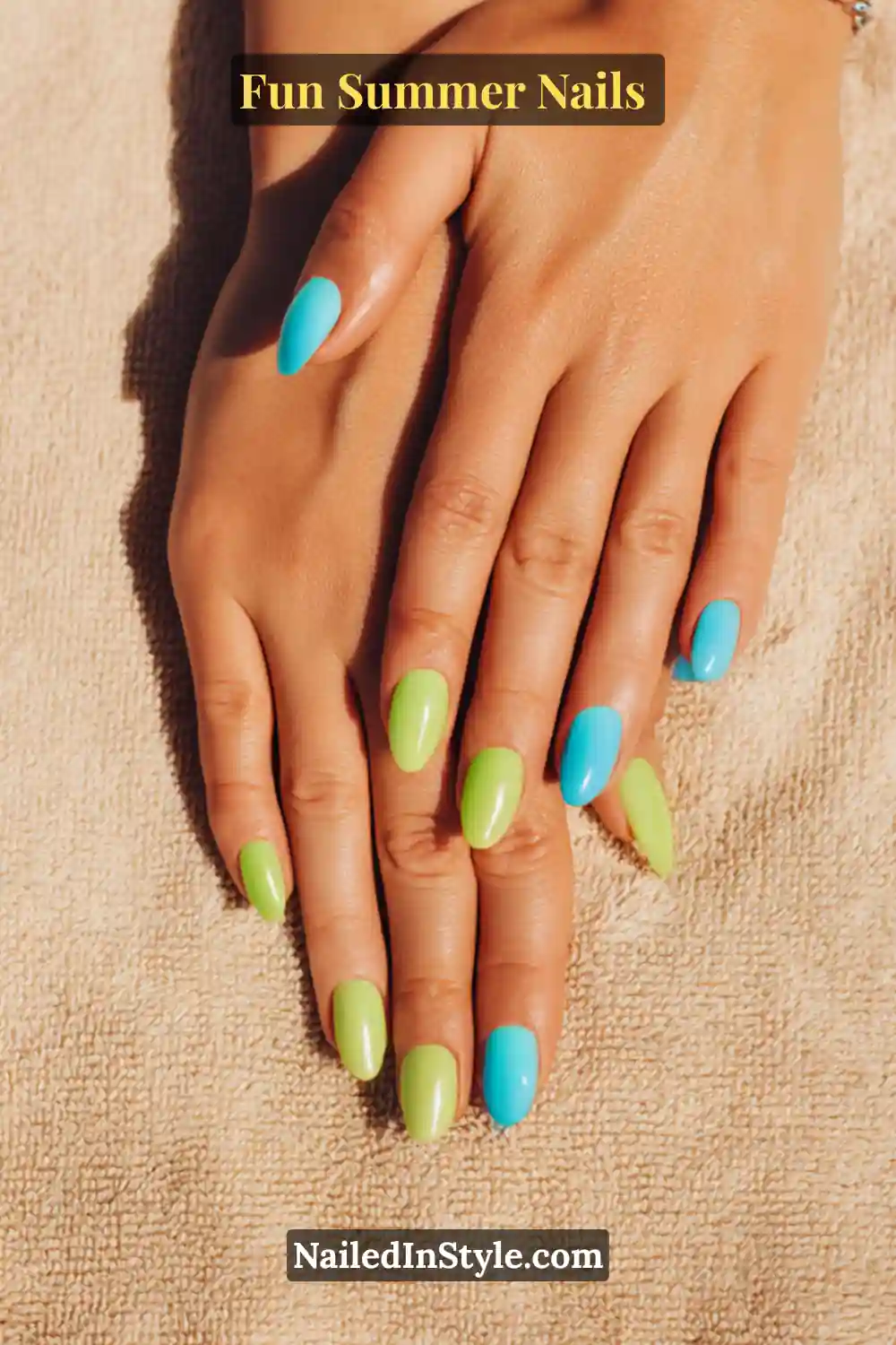 Hands with tan skin tone featuring turquoise and lime green nails, creating a vibrant contrast against bronzed skin on a sandy backdrop.