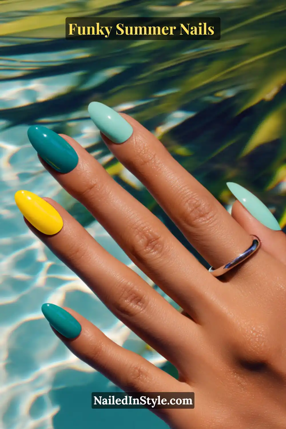Close-up of almond-shaped nails on tan skin painted in teal, aqua, and neon yellow. The glossy shades pop against bronzed skin, creating a vibrant, summery poolside vibe.