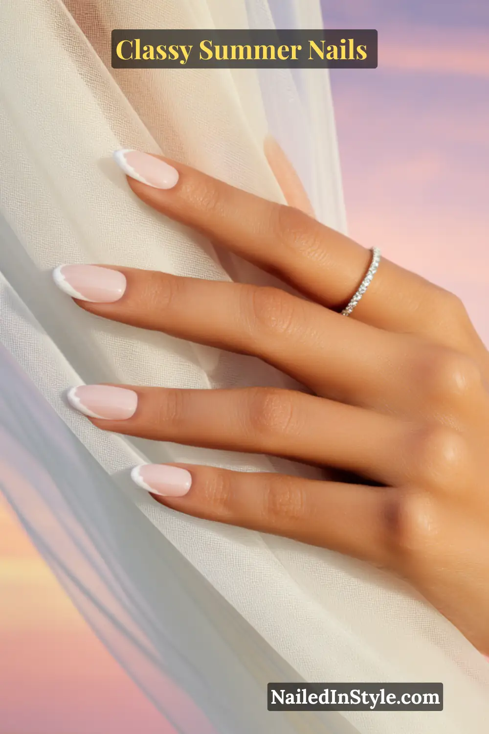 Classy Summer Nails 2026 Trends You’ll Love 3 Chic nude pink nails with thin white French tips in a glossy finish, styled in a natural almond shape for an elegant summer manicure.