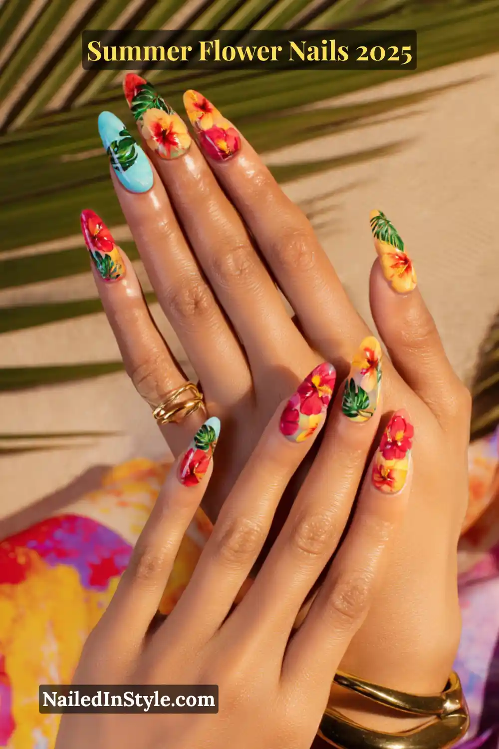 Almond-shaped acrylic nails with bold hibiscus flowers and leafy tropical patterns in coral, yellow, and turquoise tones