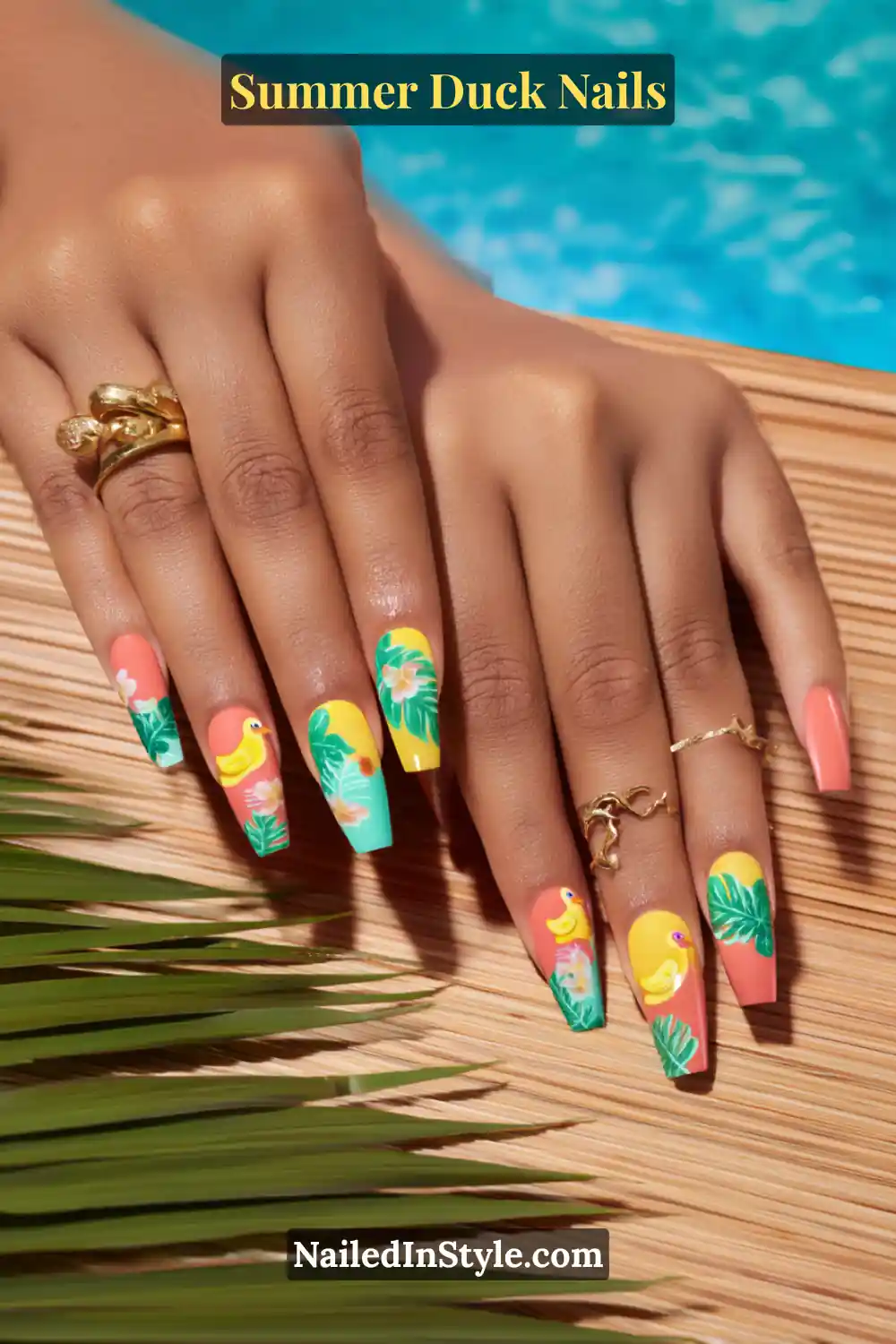 Cute Summer Duck Nails You’ll Want in 2026 6 Long coffin-shaped nails in coral, yellow, and teal, featuring playful duck art with tropical leaf designs.