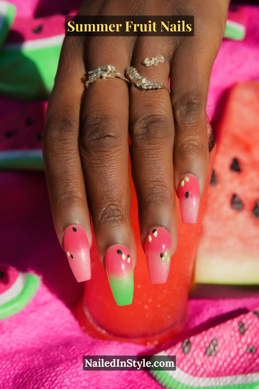 Coffin-shaped nails with a pink-to-green ombre base and black seed accents.